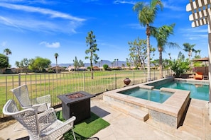 A backyard with a swimming pool, a fire pit, and outdoor seating. - The Royal Fairway | 5BR/4BA Pool, Spa & Golf Views (Indio)