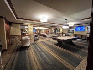 A hotel lobby with a pool table, seating area, and a television screen. - Fab 2 Bedroom+ Private Hot Tub Sept 16-24 Valdoro Mountain Lodge Breckenridge (Breckenridge)