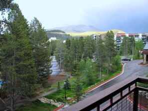 A residential area with a road, trees, and a mountain in the background. - Fab 2 Bedroom+ Private Hot Tub Sept 16-24 Valdoro Mountain Lodge Breckenridge (Breckenridge)