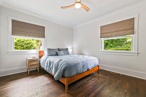 A bedroom with a bed, nightstands, a ceiling fan, and windows with blinds. - Nice 3-bedroom house in Wilmington perfect for your getaway (Wilmington)