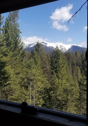 A mountain landscape with snow-capped peaks and dense forest. - Life's a Bear Haven!!  Couple's Hot Tub under the Sky!  King Bed! (Kalispell)