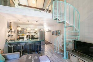A modern interior with a kitchen, bar area, and a spiral staircase. - Walk to Town/ Golf; Pool and Hot Tub (Park City)