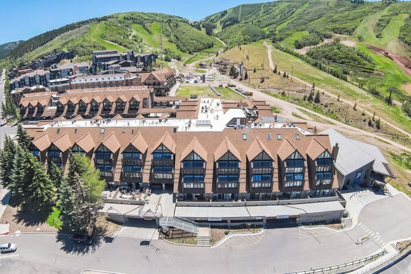 A large building with multiple windows and a parking lot. - True Ski In/ Out 3 BD Lodge at Mtn Village, Pool, Hot Tub, Fitness (Park City)