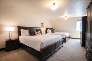 A bedroom with two beds, nightstands, a dresser, and a ceiling light fixture. - True Ski In/ Out 3 BD Lodge at Mtn Village, Pool, Hot Tub, Fitness (Park City)