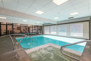 An indoor swimming pool with clear water, surrounded by glass walls and a tiled floor. - True Ski In/ Out 3 BD Lodge at Mtn Village, Pool, Hot Tub, Fitness (Park City)
