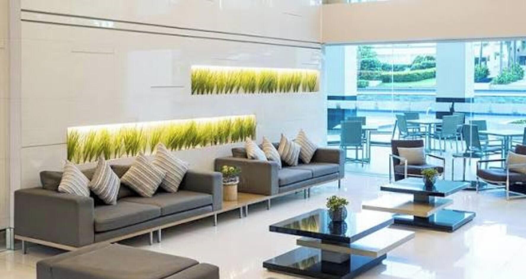 A modern interior with a sofa set, a coffee table, and a wall-mounted plant.