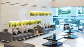 A modern interior with a sofa set, a coffee table, and a wall-mounted plant.