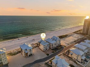 A beachfront property with multiple buildings, a sandy beach, and the ocean. - Gulf front | Heated Private Pool |Sleeps 18 | Bonfire Incl (Panama City Beach)