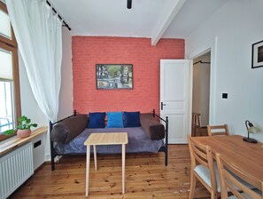 A room with a brick wall, a bed, a table, and a chair. - 1910 Pera Apartment • 2BR Home • Istiklal & Galata (İstanbul)