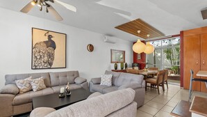 A modern living room with a sofa set, a coffee table, and a dining area with chairs and a table. - Peaceful and Fully-Equipped 3-Bedroom Retreat (Bucerías)