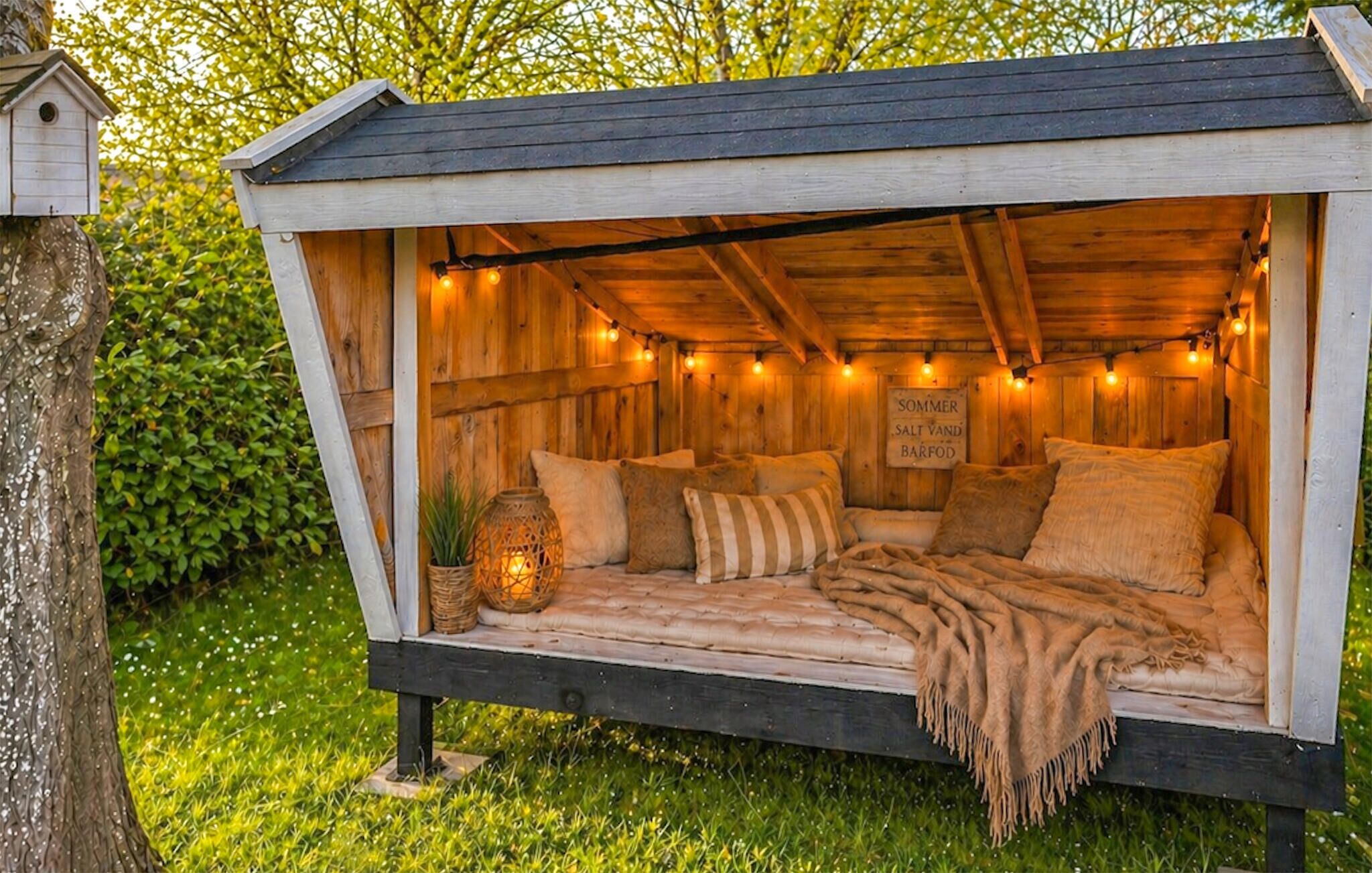 A cozy wooden cabin with a bed, pillows, and a sign indicating it is a summer salt and sand bar.