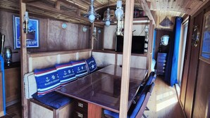 A wooden interior with a glass table, wooden benches, and a ceiling with exposed beams. - Unique house in the heart of Fouras - 2 guests (Fouras)