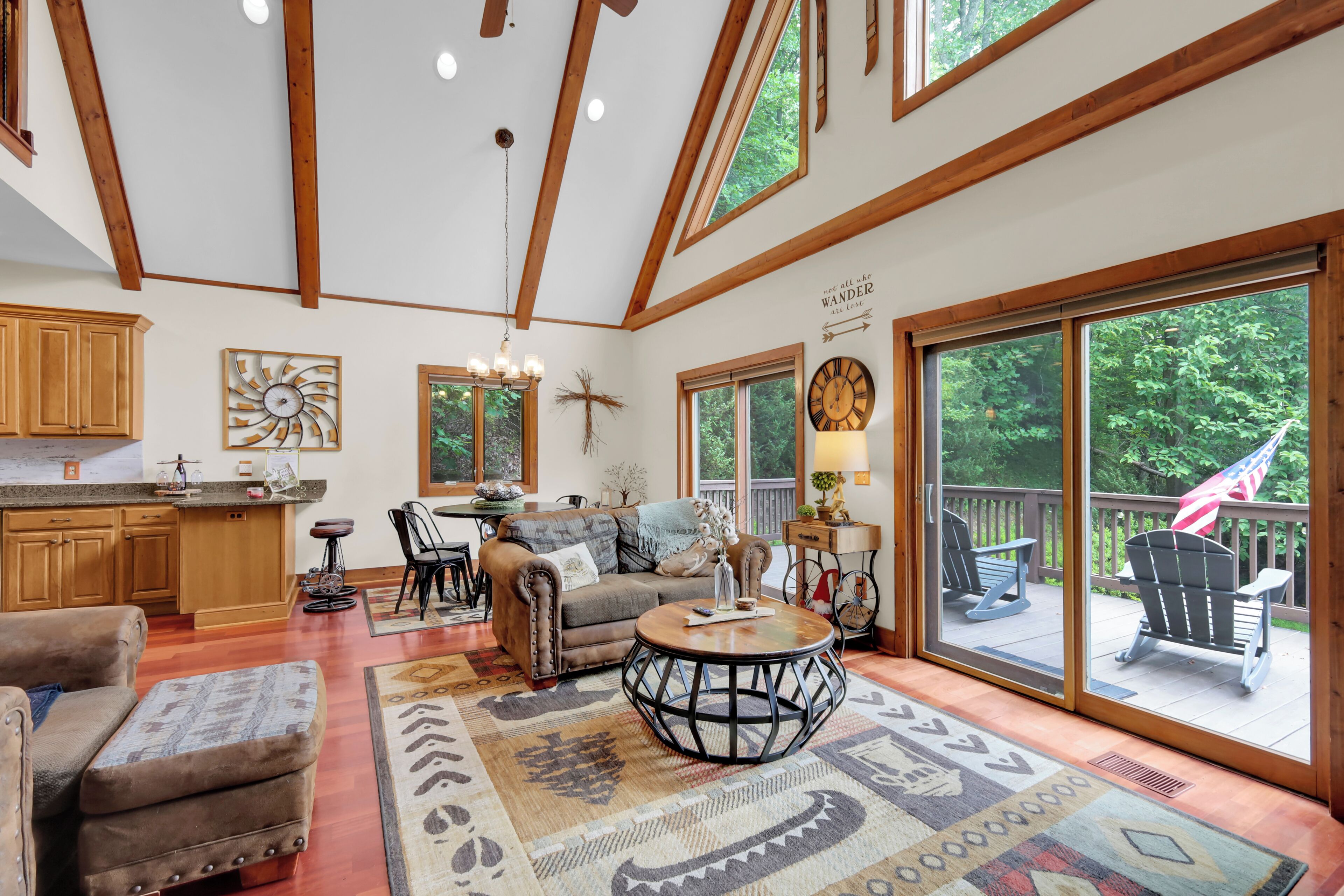 A spacious living area with a large window, a fireplace, and a cozy seating arrangement.