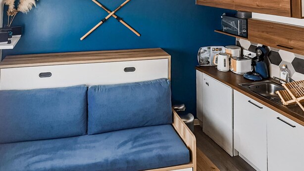 A compact kitchenette with a microwave, toaster, and coffee maker.