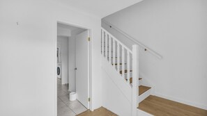 A staircase with white railings and wooden steps leading to an upper floor. - Callow Place 10 - town location, relaxation, easy coastal living, Wifi (Bermagui)