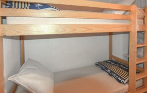 A bunk bed with a pillow and a blanket. - 1 bedroom beautiful apartment in Le Grau-du-Roi (Le Grau-du-Roi)