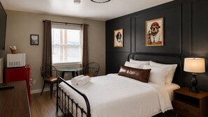 A hotel room with a bed, bedside table, lamp, and a desk with a chair. - Comfy & Pet Friendly Stay Near Cooperstown - ADA (East Springfield)