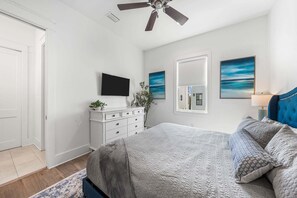 A bedroom with a bed, a dresser, a television, and artwork on the walls. - Sleeps 20! LSV/Golf Cart, Bikes & Private POOL! Pet-Friendly! (Santa Rosa Beach)