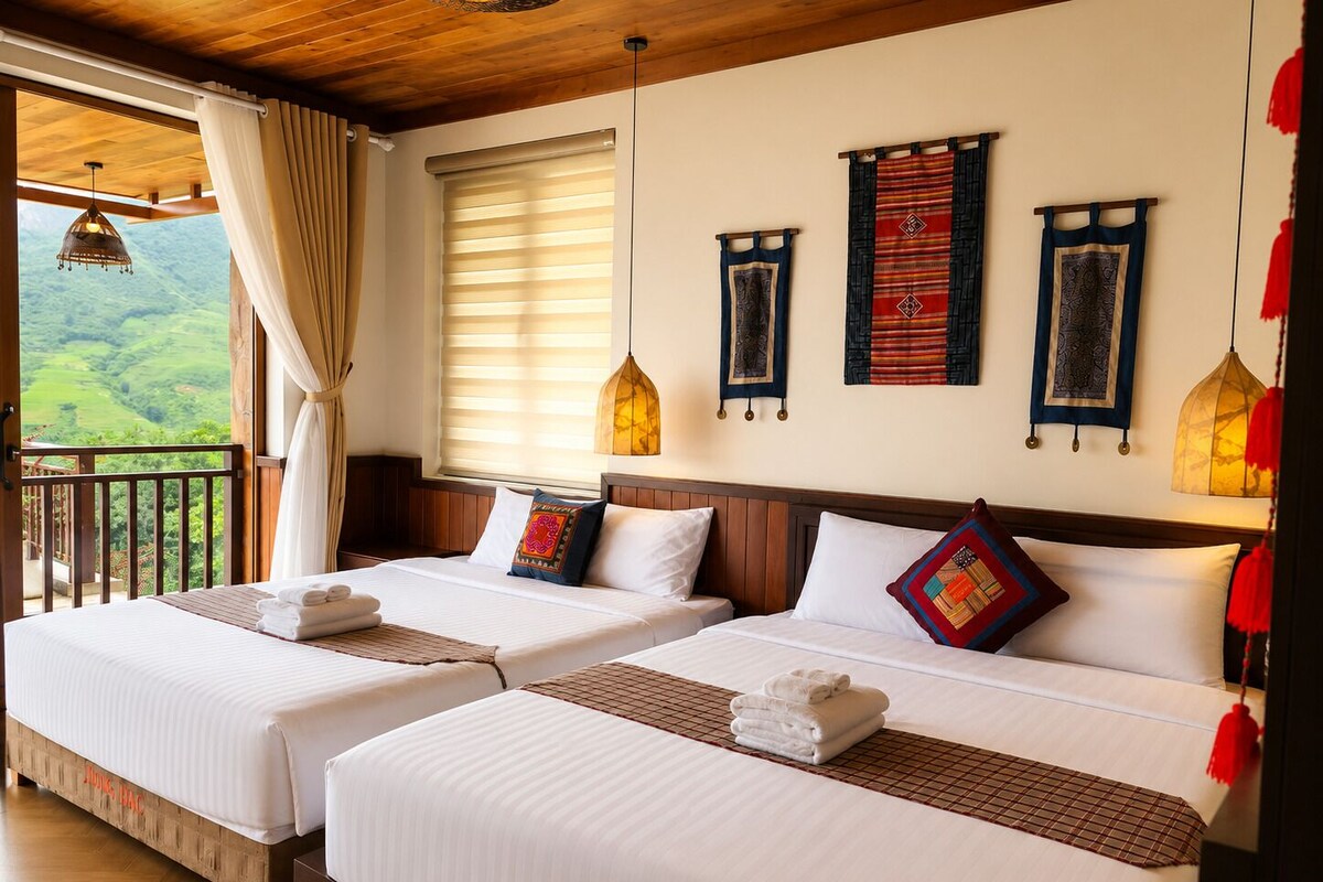 A hotel room with two beds, a balcony, and a view of the countryside.