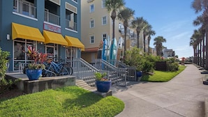 A coastal hotel with a yellow awning, bicycles, and surfboards. - Sleeps 30! LSV/Golf Cart, Private Pool, HotTub, & Game Room! Pet-Friendly (Santa Rosa Beach)