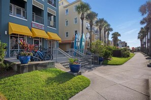 A coastal hotel with a yellow awning, bicycles, and surfboards. - Sleeps 30! LSV/Golf Cart, Private Pool, HotTub, & Game Room! Pet-Friendly (Santa Rosa Beach)