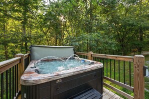 A hot tub on a wooden deck surrounded by trees. - New! Dollywood, Views, Hot Tub, Fireplace, Easy Rd (Sevierville)
