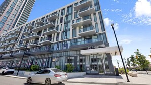 A modern building with multiple balconies, large windows, and a sign reading '10 Lagerfeld.' - Brampton Modern Condo by GO Station (Brampton)
