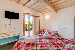 A bedroom with a bed, a desk, a TV, and a wardrobe. - Family Home Margherita Pool Mugello 2, Vicchio, Italy (Vicchio)