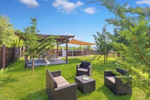 A patio with wicker furniture, a pergola, and a pool in the background. - Family Home Margherita Pool Mugello 2, Vicchio, Italy (Vicchio)