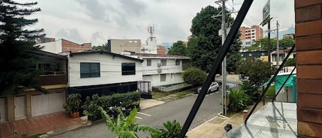 Vista de una calle residencial con casas, cielo despejado y una línea eléctrica.