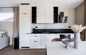 A modern kitchen with white cabinetry, a black countertop, and a built-in oven. - Awesome home in Voorthuizen with WiFi (Voorthuizen)