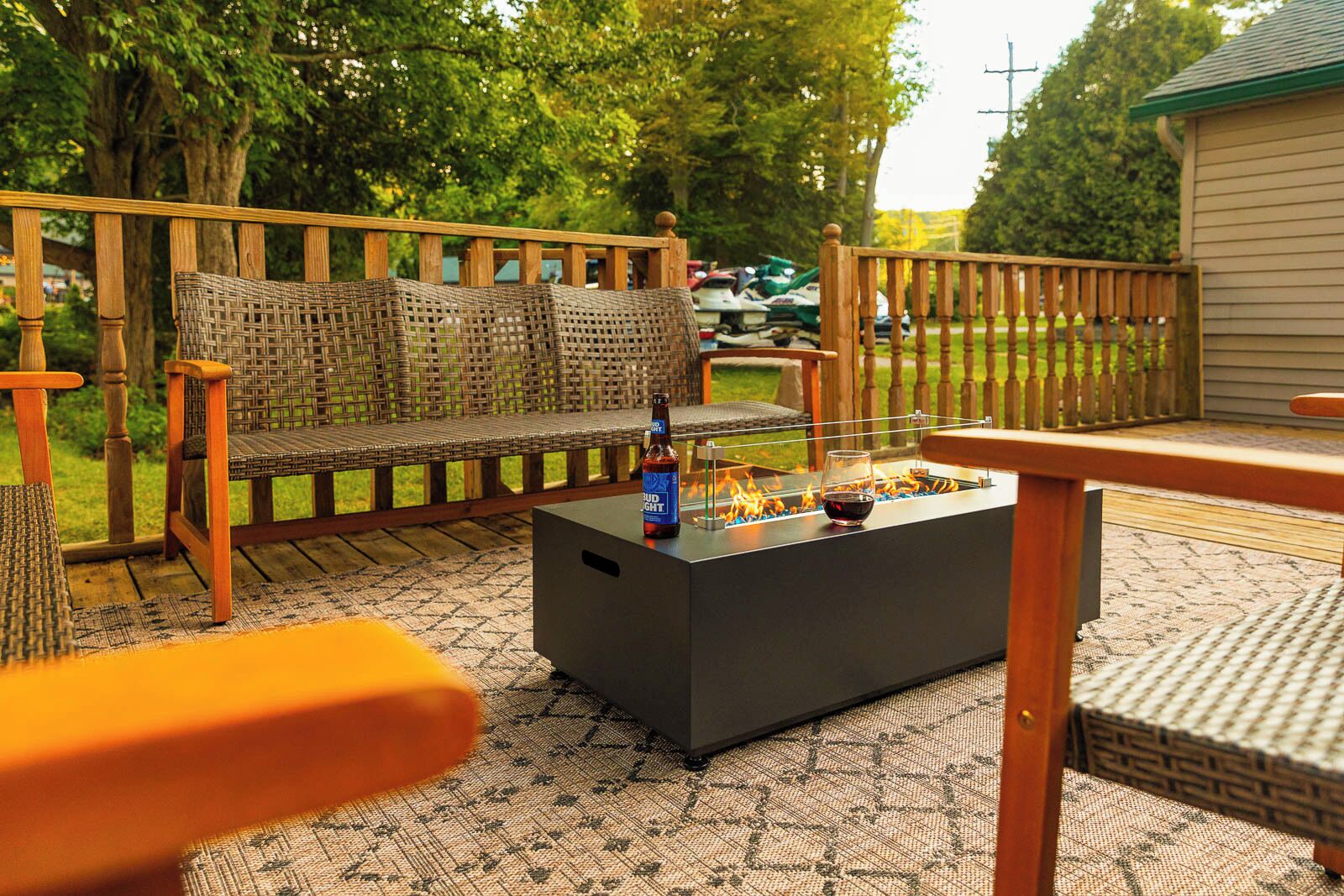 An outdoor seating area with a fire pit, a sofa, and a table.