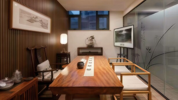 A conference room with a wooden table, chairs, a framed picture, a small table with decorative items, and a window with blinds. - Chengdu Jian Shan Hall Hotel (Chengdu)