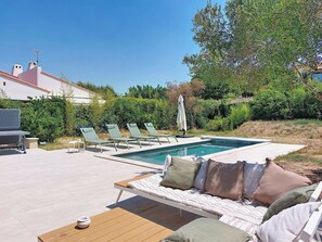 A poolside area with lounge chairs, a sofa, and a barbecue grill. - La Villa Nana by Interhome (Saint Cyr sur mer Les Lecques)