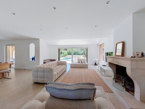 A modern living room with a sectional sofa, a fireplace, and a view of the outdoors. - La Villa Nana by Interhome (Saint Cyr sur mer Les Lecques)