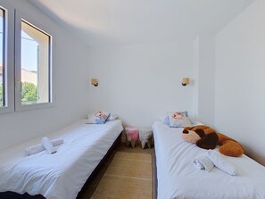 A room with two single beds, a small stool, and a window. - La Villa Nana by Interhome (Saint Cyr sur mer Les Lecques)
