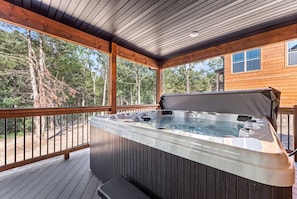 A hot tub on a wooden deck with a view of trees. - NEW! Tall Timbers! Private Indoor Pool! (Hollister)