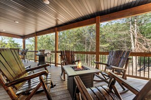 An outdoor deck with wooden furniture, a grill, and a fire pit. - NEW! Tall Timbers! Private Indoor Pool! (Hollister)