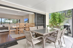 Un vaste espace de vie comprenant une table à manger, des chaises et une grande fenêtre.