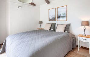 A bedroom with a large bed, two bedside tables, a lamp, and two framed pictures on the wall. - Beautiful home in Hemmet with sauna (Hemmet)