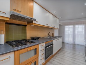 A modern kitchen with a gas stove, oven, and a built-in microwave. - Marina retreat with lake view (Lagos)