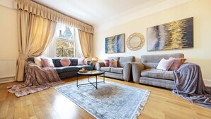 A living room with two sofas, a coffee table, and a rug. - Deluxe 2 Bedroom Apartment In An Amazing Location (London)