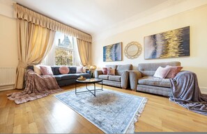 A living room with two sofas, a coffee table, and a rug. - Deluxe 2 Bedroom Apartment In An Amazing Location (London)