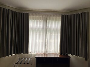 A room with a window, a chair, and a desk. - One Bedroom Mountain Respite at Crosswinds (Tagaytay City)