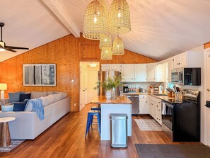 A modern kitchen with white cabinets, stainless steel appliances, and a wooden ceiling. - Lakefront Escape - Dock, Beach, Grill & Hot Tub (Milton)