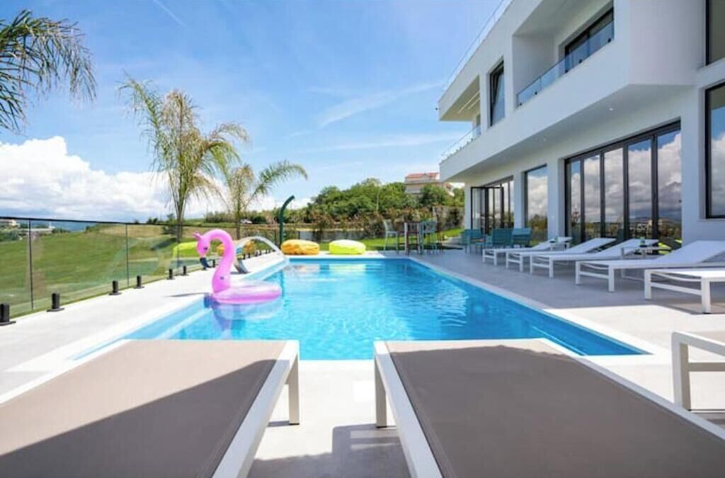 A modern pool area with lounge chairs and a swan float.