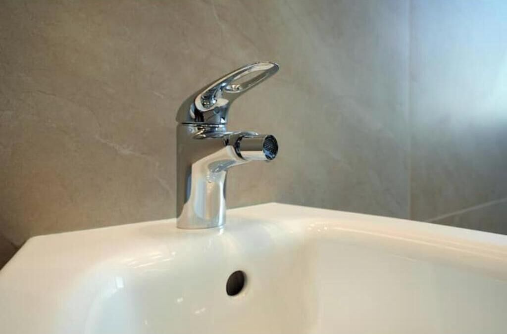 A bathroom sink with a chrome faucet and a single-hole drain.