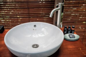 A white sink with a modern faucet, a soap dispenser, and a small round tray with a bottle. - Oak House Sidemen (Sidemen)