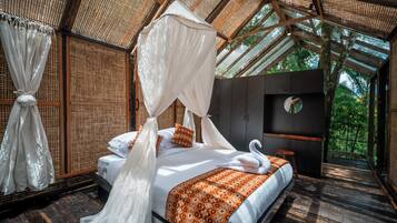 A room with a bed, canopy, and a view of the outdoors.