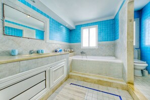 Een douche, handdoeken, zeep, toiletpapier